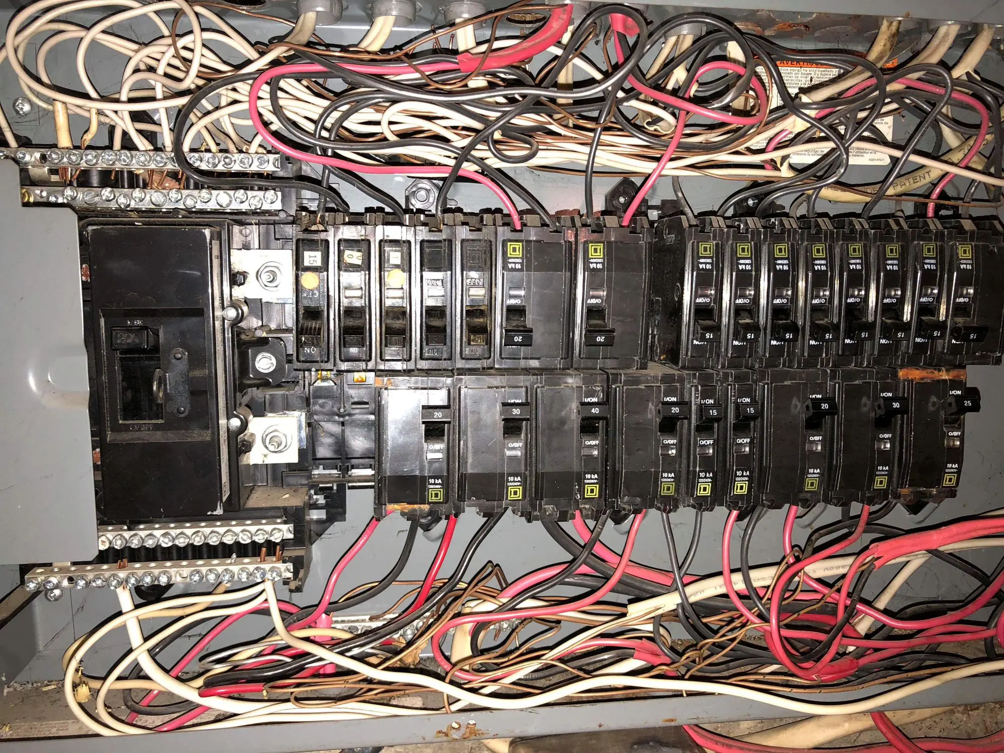 Electrical panel with multiple circuit breakers.