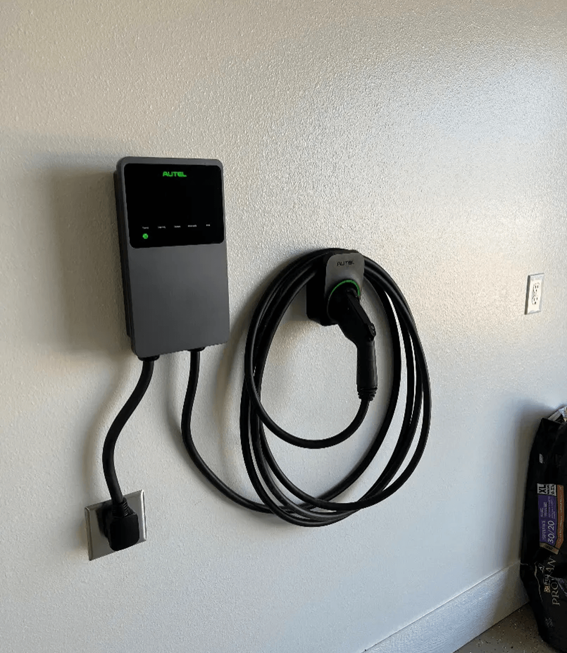 Electric vehicle charger mounted on wall.