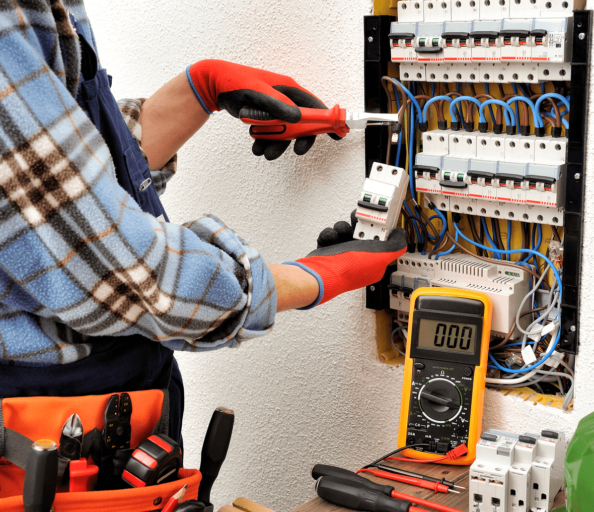 Electrician working on a circuit breaker panel.