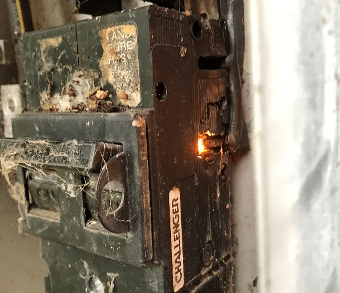 Sparking electrical breaker with cobwebs.