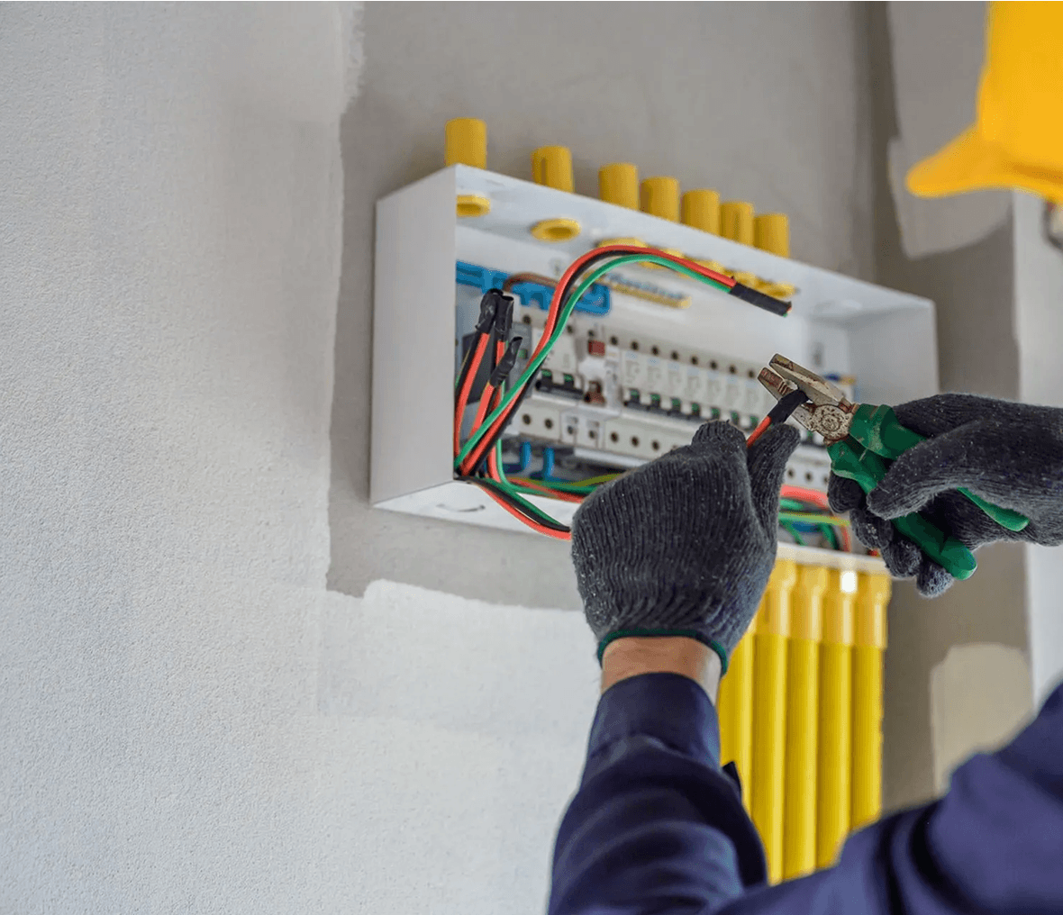Electrician working on circuit breaker panel.