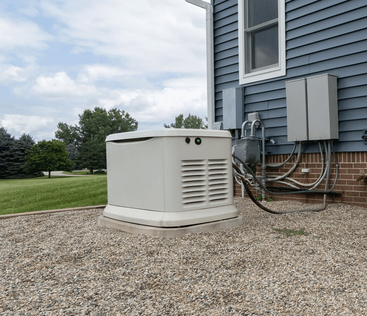 Home backup generator beside blue house.