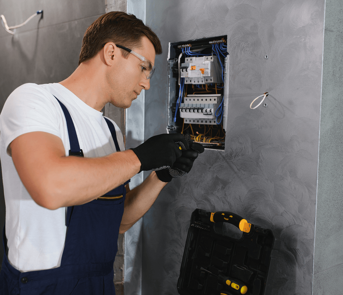 Electrician working on circuit breaker panel.