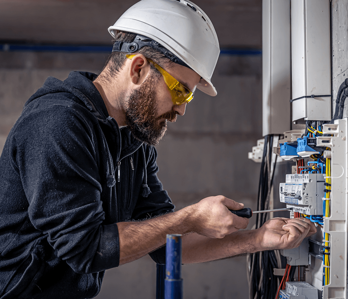 Electrician fixing wires in a circuit box.