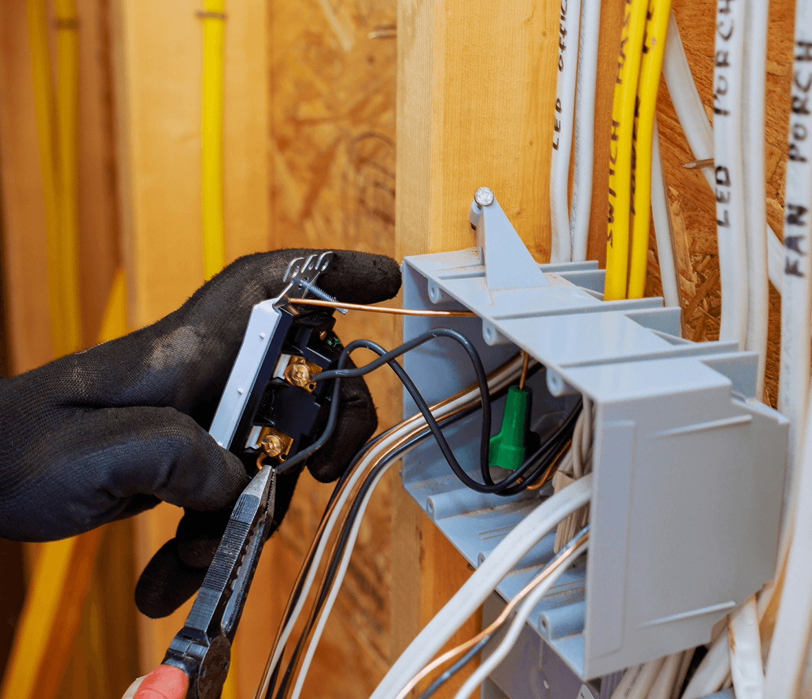 Electrician wiring a switch in progress.