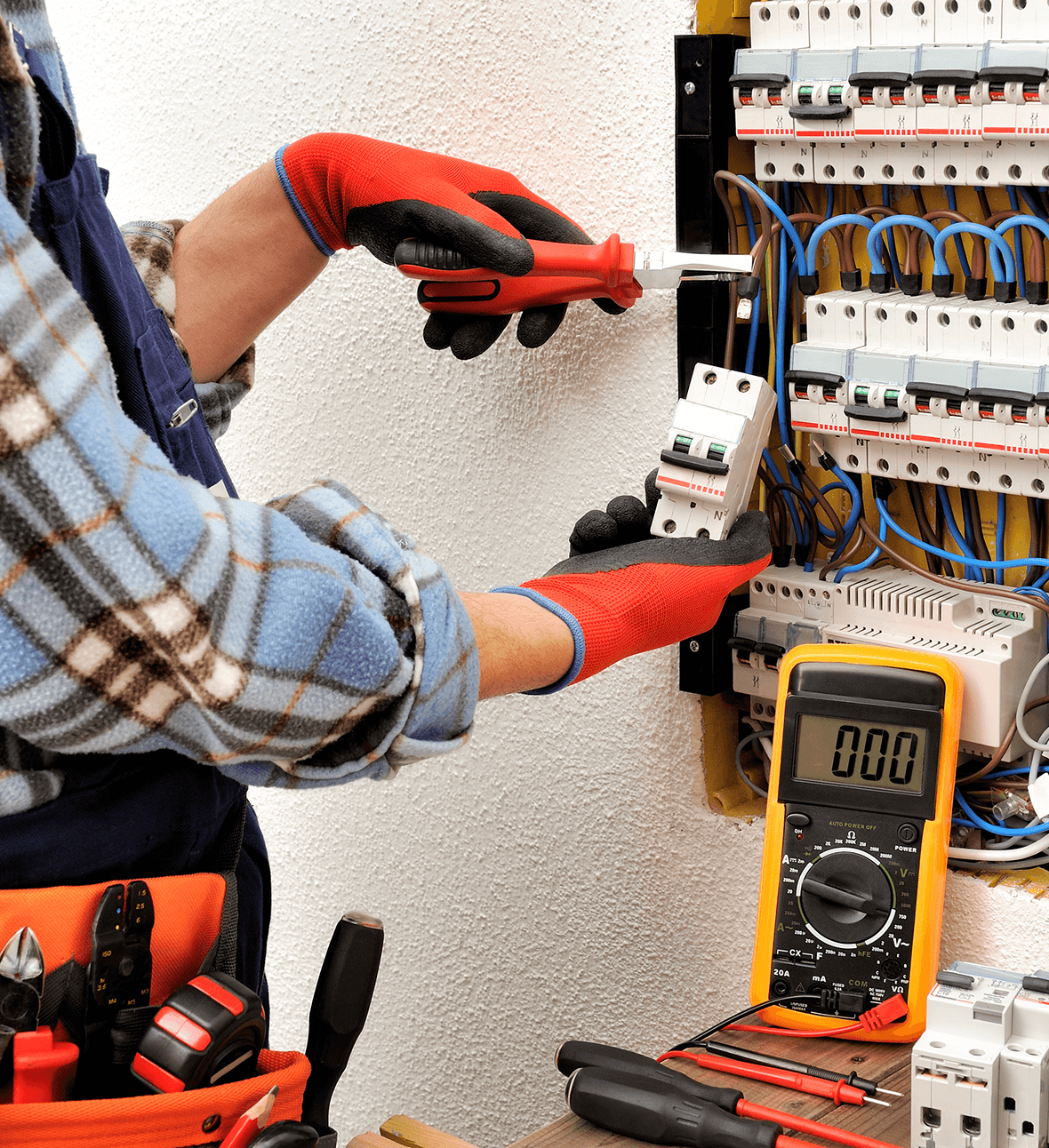Electrician working on a circuit breaker panel.