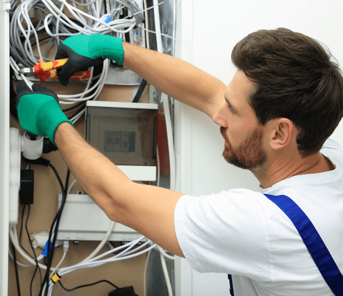 Electrician working on a complex wiring system.
