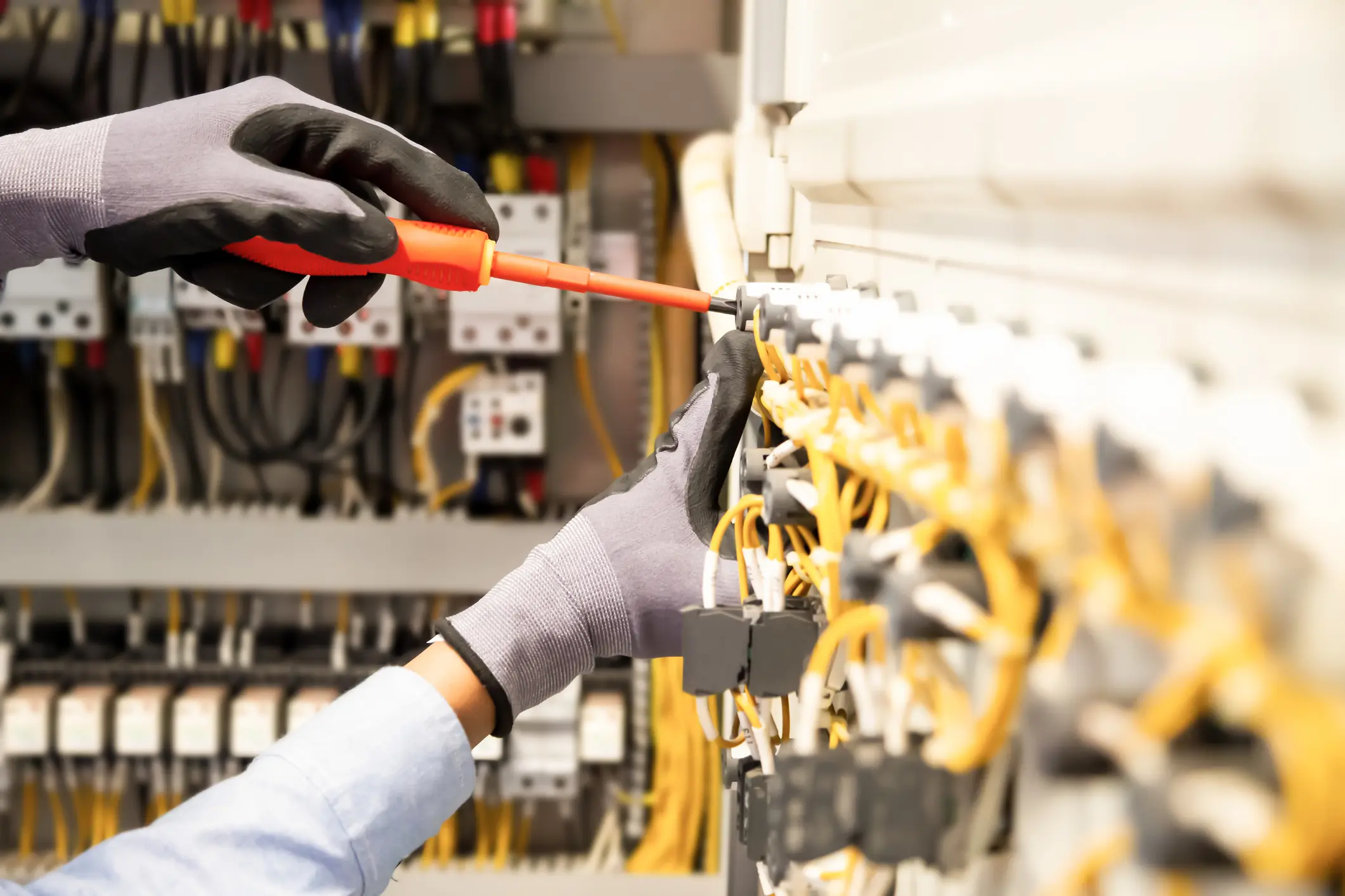 Electricians work to connect electric wires in the system, switchboard, electrical system in Control cabinet.