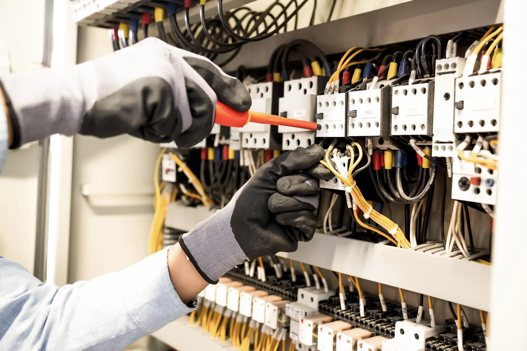Electricians work to connect electric wires in the system, switchboard, electrical system in Control cabinet.