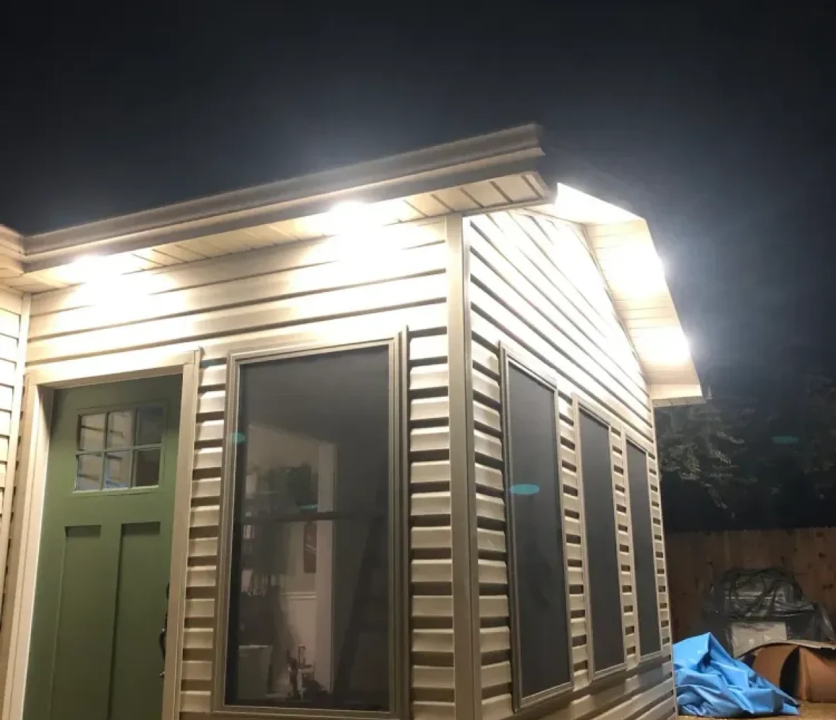 Small illuminated building exterior at night.